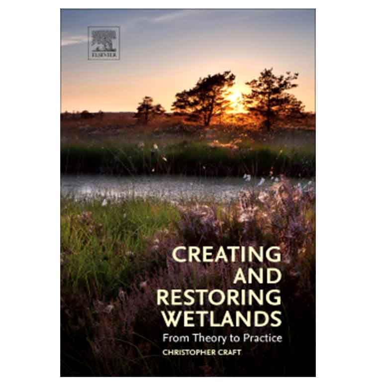 James Barnes in front of a wall of photos. 