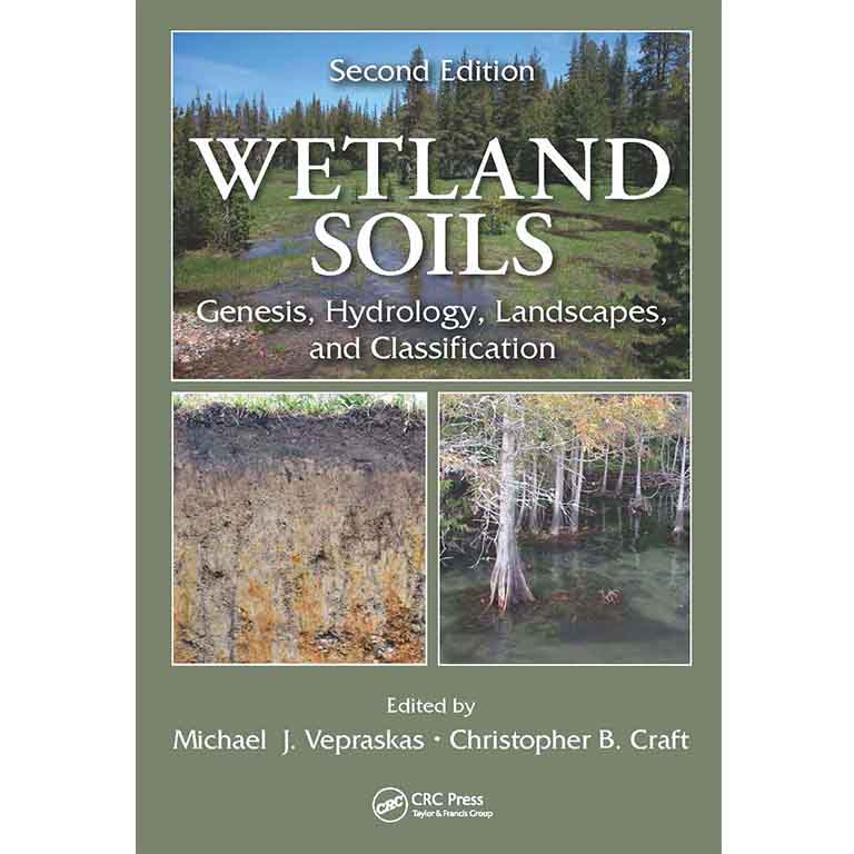 James Barnes in front of a wall of photos. 