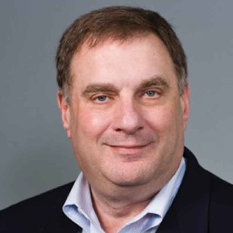 Alumnus Smalley puts his hand on his heart. 