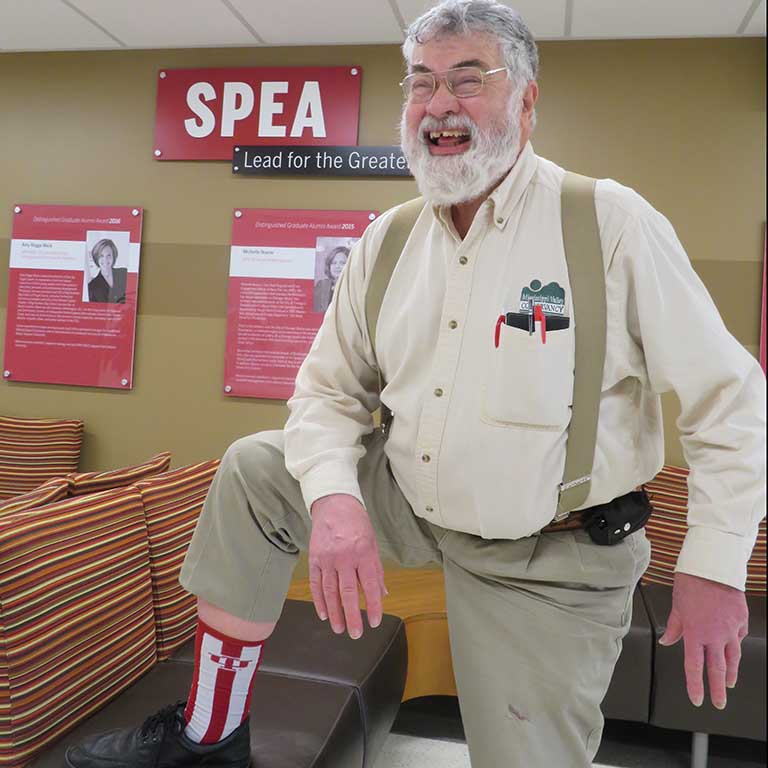 Smiling man shows off his striped socks